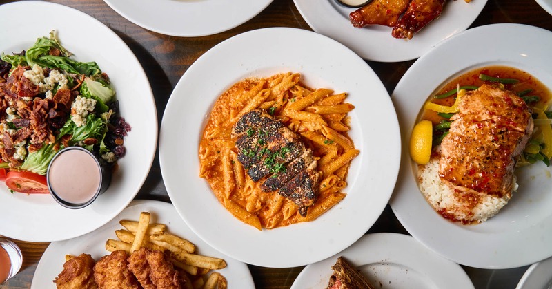 A variety of dishes spread on a wooden table