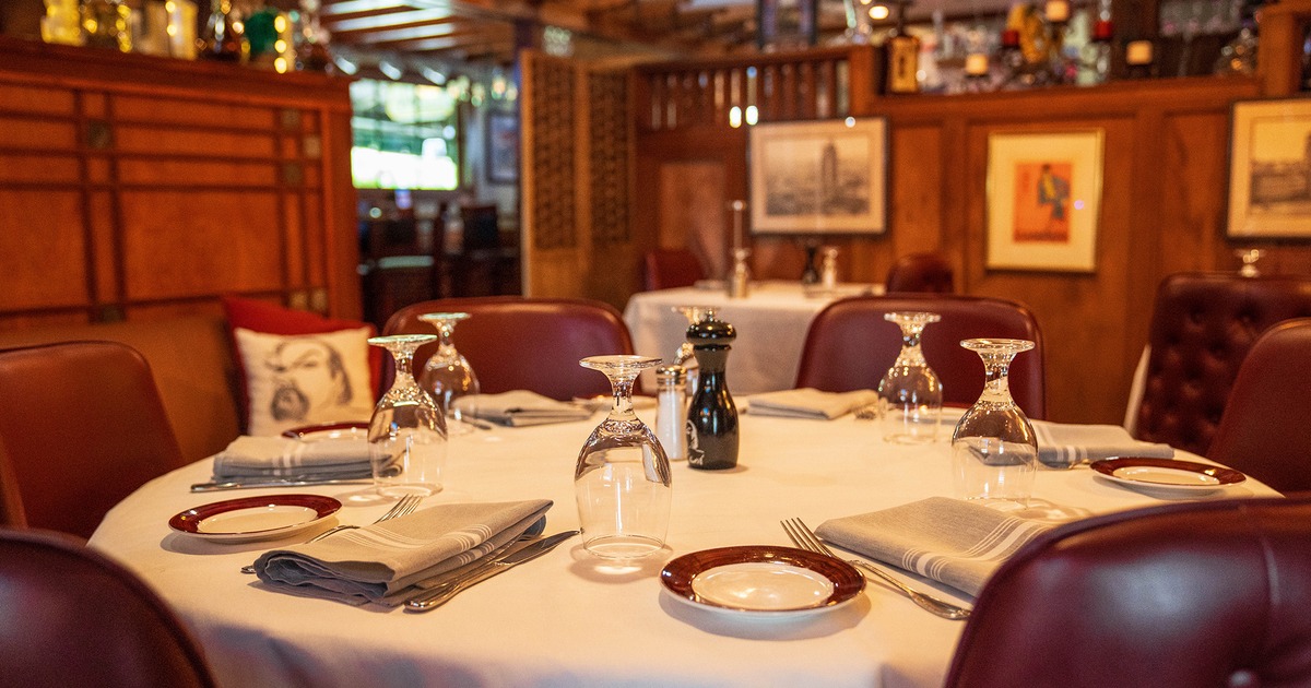 Elegant round dining table set for guests, close up