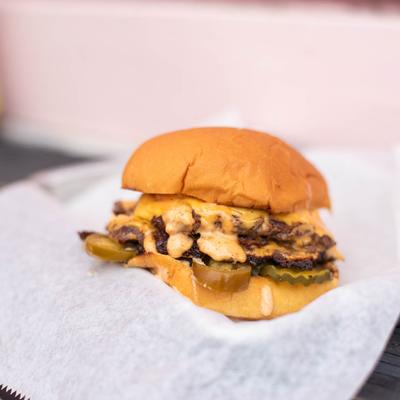 Double brisket burger, with cheese, caramelized onion, pickles, and house sauce.