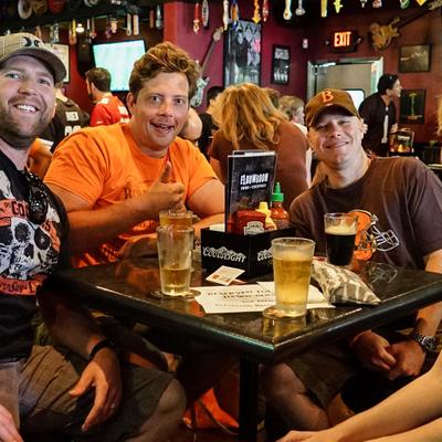 A group of guys drinking beers and posing