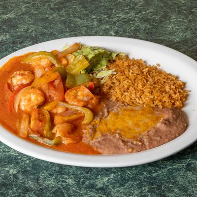 Spicy Mexican tomato-sauced shrimp served alongside rice, refried beans and guacamole.