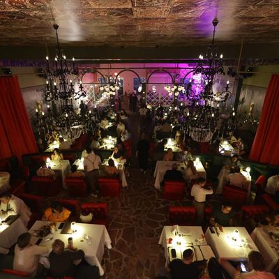 A view of the dining area from the top of the room. People having dinner.