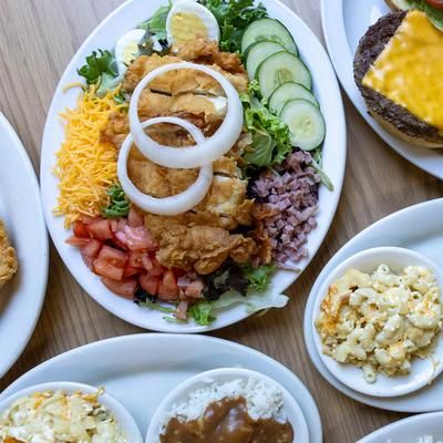 A wooden table is filled with various dishes.
