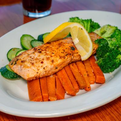 Salmon Power Plate with carrots, broccoli, lemon slice and zucchini.