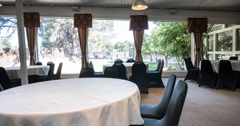 Banquet room interior, several round tables covered with  white table cloths