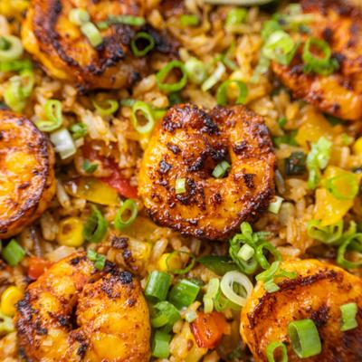Blackened shrimp over seasoned rice with sliced scallions.