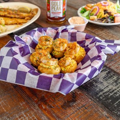 Fried Deviled Eggs served alongside other foods and bottle of Iced Tea.