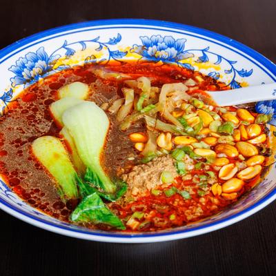 Spicy noodle soup with bok choy, peanuts, scallions, and chili oil.