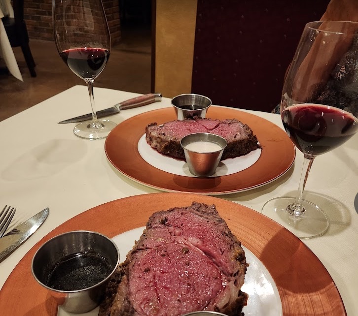 Restaurant table with two prime rib dinners.