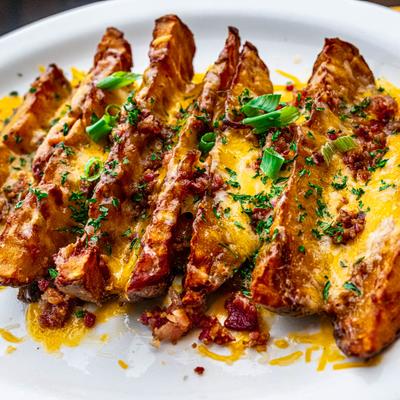 Potato wedges topped with bacon and melted cheese.