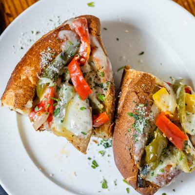 Sandwich with Italian sausage, red peppers, onion and provolone