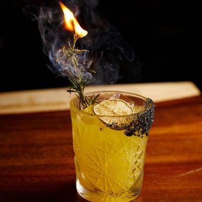 Margarita cocktail with a burning rosemary.