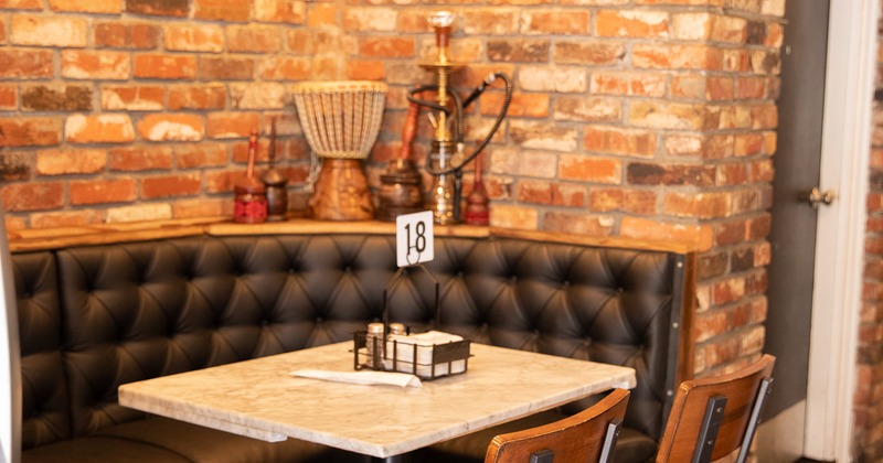 Booths, table and chairs in the corner of restaurant