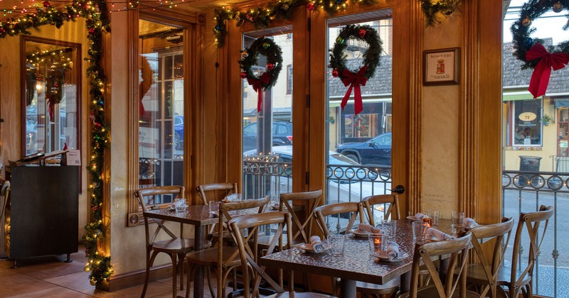 Restaurant interior, cozy dining area with set tables, Christmas decoration