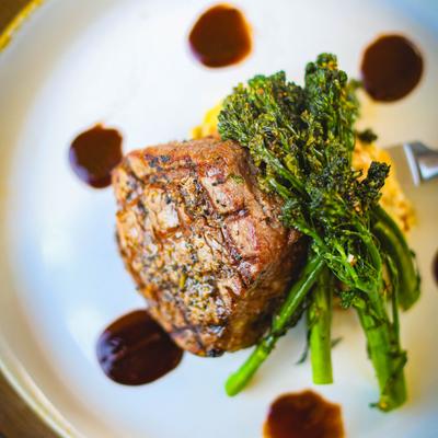 Filet mignon steak served with asparagus, top view.
