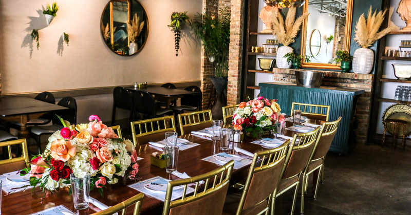 Interior, dining room, set dining table decorated with bundles of flowers