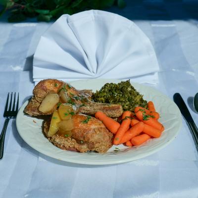 Porkchops with sides of colard greens and carots.