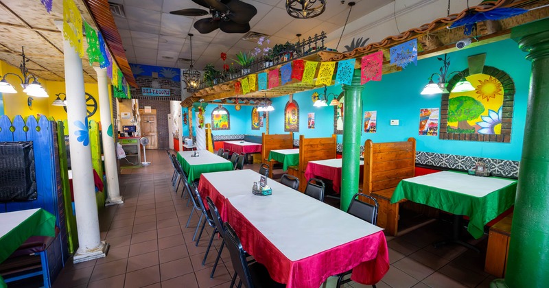 Interior of a colorful restaurant with decorated tables and walls