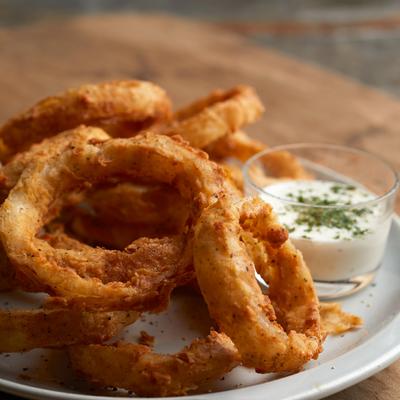 Crispy onion rings with dipping sauce.