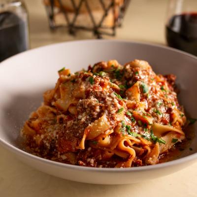 Tagliatelle pasta with beef ragu sauce and Parmesan cheese.