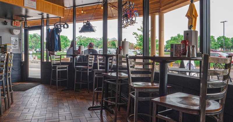 Interior, tables and chairs by the windows