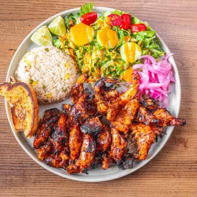Grilled butterfly shrimp marinated in adobo, served with rice and mix salad.