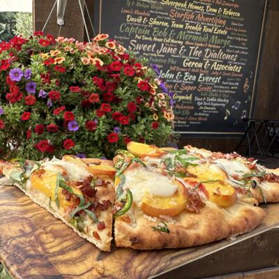 Food and a flower arrangement on a table.