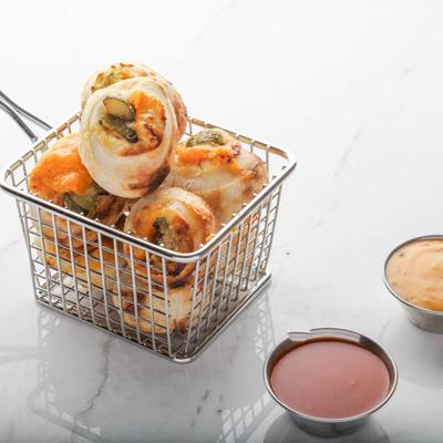 Cheesy jalapeno pinwheels with hot sauce and creamy sauce.