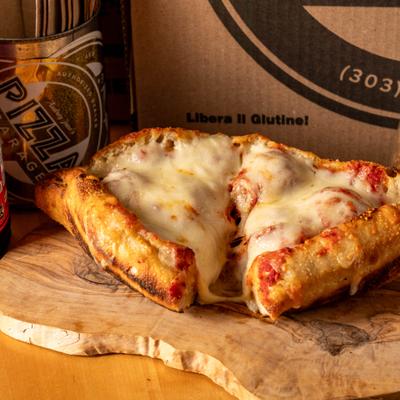 A meatball grinder split open, showing melted cheese.