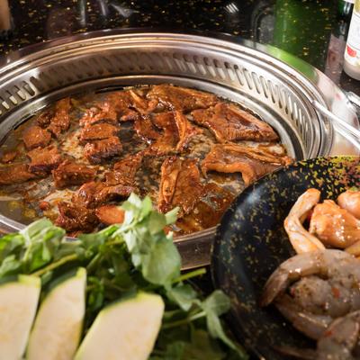 Food in a frying container in the middle of a table.