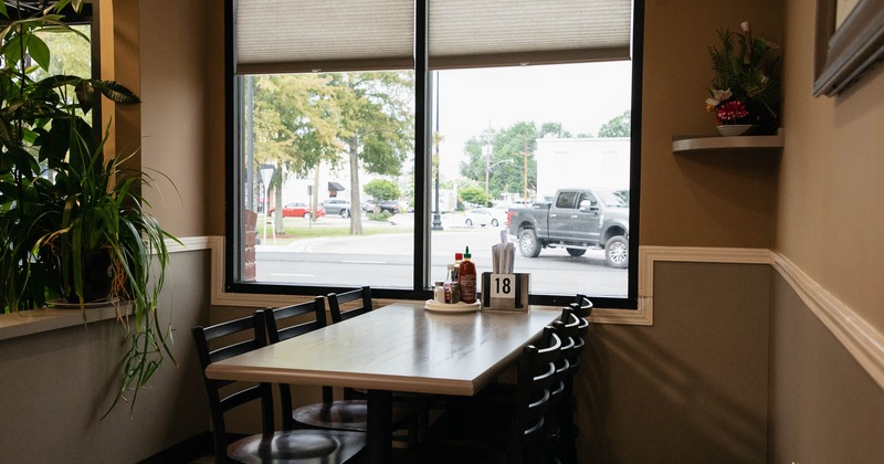 Interior, table and chairs by the  window