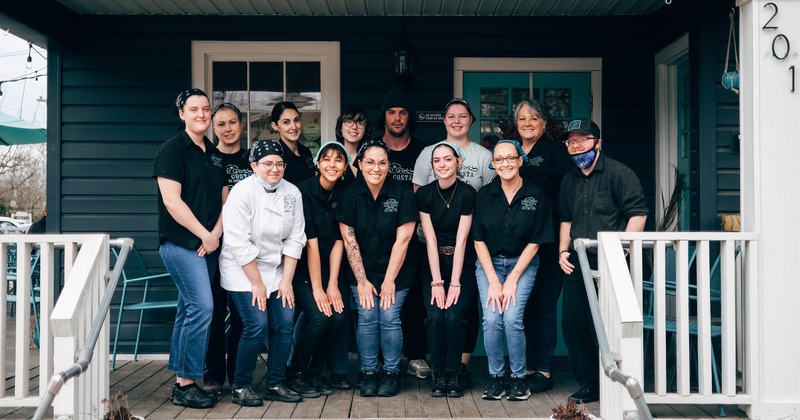 Exterior, smiling staff grouped together for a photo