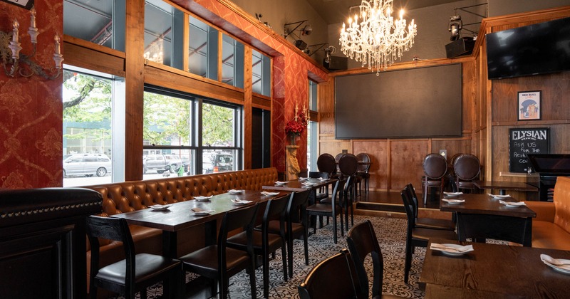 Inside, restaurant dining room with leather booths, set tables, patterned tile flooring