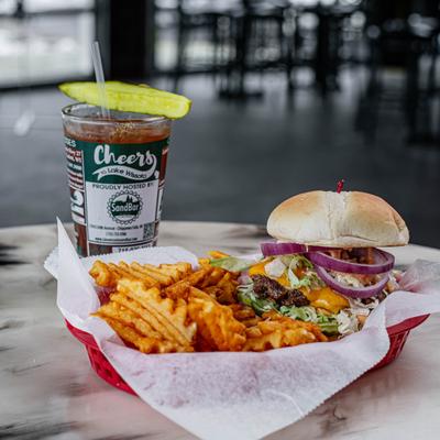 Cheeseburger basket with waffle fries and a drink.