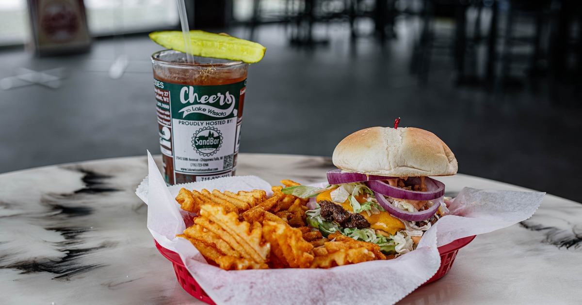 Boss Mac Burger with waffle fries, pickle spear, and an iced drink