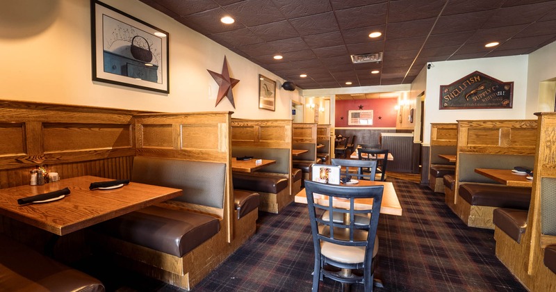 Interior, wide view of dining area, tables ready for guests