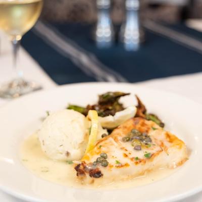 Chilean Seabass Piccata topped with capers, served with mashed potatoes and Brussels sprouts.