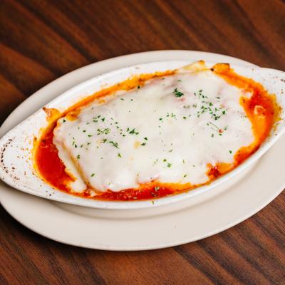 Lasagna topped with melted cheese.