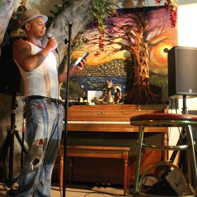 A person on the stage holding the microphone and a phone.