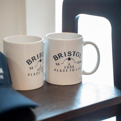 Two white ceramic mugs printed with 