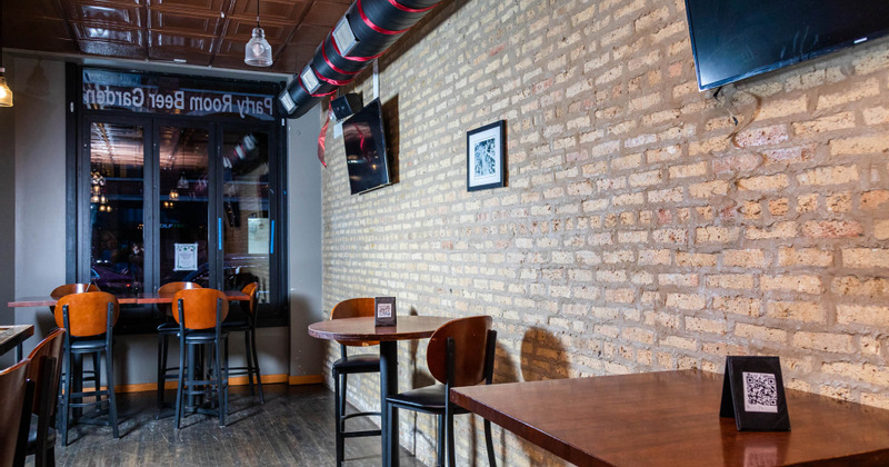 Interior, tables lined up by the brick wall