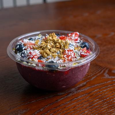 Strawberry Bowl topped with berries, crunchy granola, and coconut flakes.
