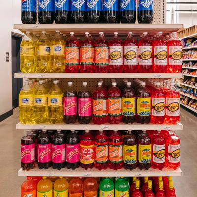 Soda drink selection displayed on store shelves.