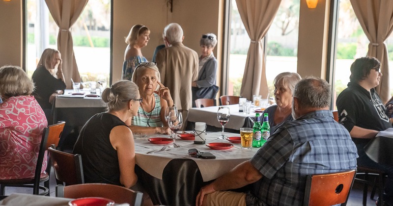 Interior, guests sitting in the dining room