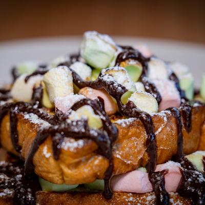 French toast stacked with marshmallows and chocolate drizzle.