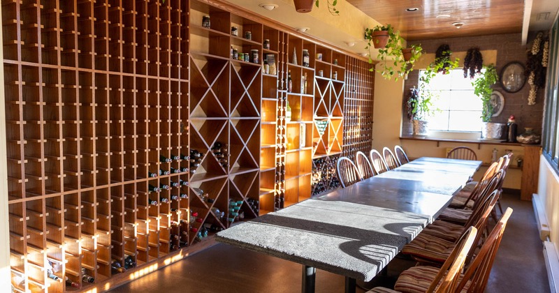 Interior, a room with wine racks, table and seats