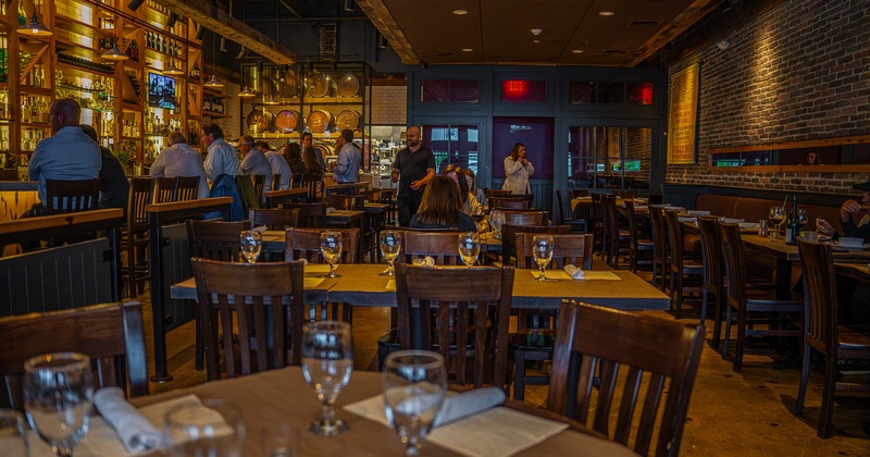 Interior space, seating area with set dining tables and bar area