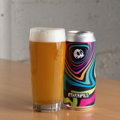 Can of beer with a psychedelic swirl design, alongside a glass.