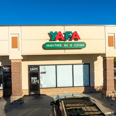 Restaurant's entrance with a sign above it.