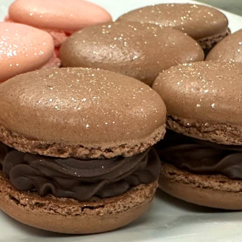 Chocolate macaron filled with chocolate ganache and raspberry photo